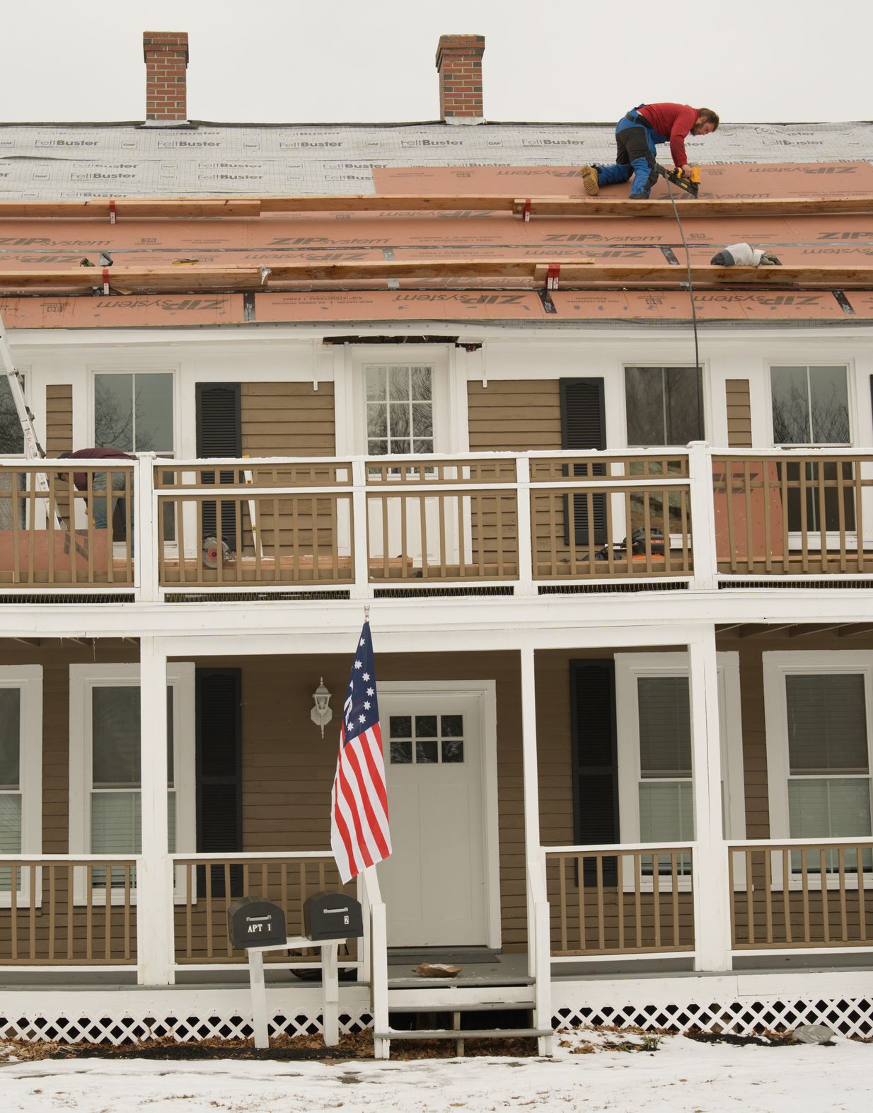 Atlas team member reviewing remodeling work on a roof
